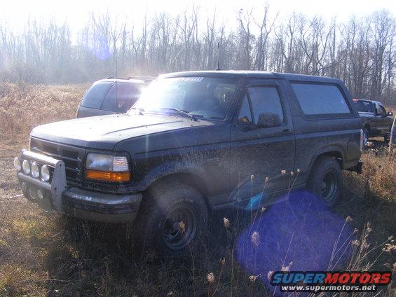 Dark 1996 Ford Bronco 3/4 front view with brush guard and auxiliary lights