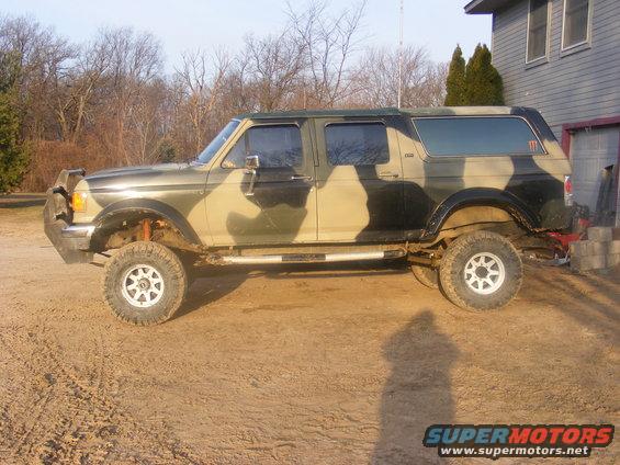 Camouflaged four-door Ford Bronco with lifted suspension and off-road tires