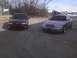 2003 Ford Crown Victoria - A 2003 Ford Crown Victoria is parked next to a maroon sedan in an outdoor lot.