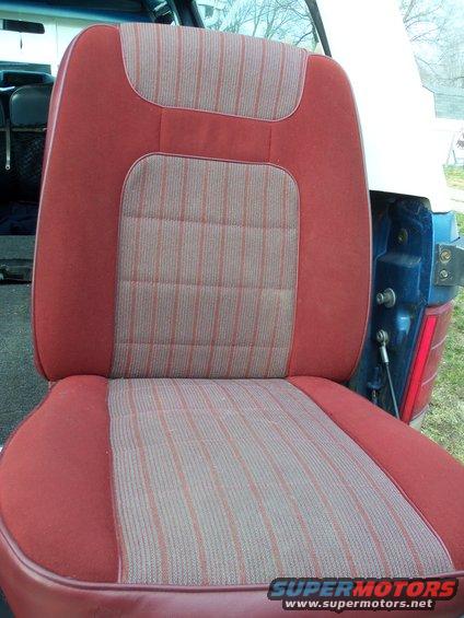 Red and tan striped seat interior of a 1985 Ford Bronco