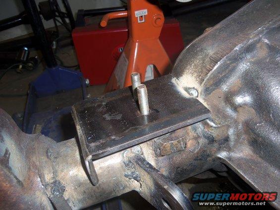 Modified rear axle assembly with a metal plate and two bolts attached