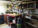 2004 Aston Martin Virage - A cluttered workbench and storage shelves in a garage or workshop setting.