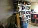 2004 Aston Martin Virage - A cluttered room with shelves holding various items, including tools and storage containers.