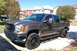 2007 GMC Sierra 1500 - A brown 2007 GMC Sierra 1500 pickup truck is parked in a driveway on a sunny day.
