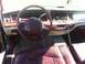 1997 Lincoln Town Car - The interior of a 1997 Lincoln Town Car shows cracked burgundy leather seats and a wood-trimmed dashboard.