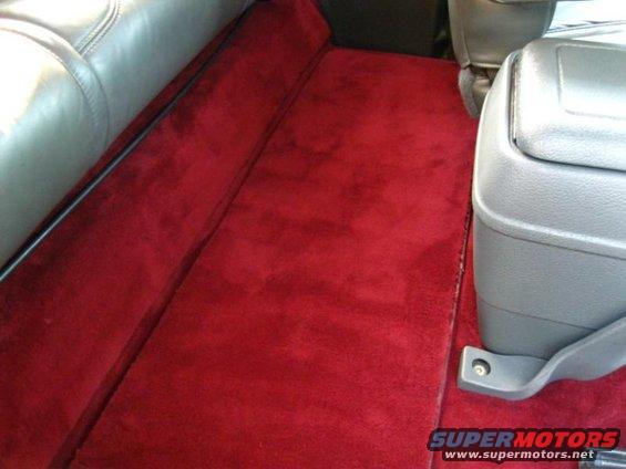 Red carpet and gray center console in vehicle interior