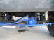 1992 Ford Bronco - Undercarriage view showing blue-painted suspension parts and a Rough Country shock absorber. The registry claims this is a 1992 Ford Bronco.