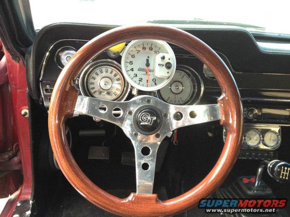 1968 Ford Mustang interior with wood steering wheel and gauges
