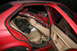 1996 BMW 3 Series - Interior view of a red 1996 BMW 3 Series sedan showing damage to the roof and debris inside.