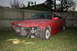 1996 BMW 3 Series - This red 1996 BMW 3 Series sedan shows significant damage to its front end, including the grille and bumper area.