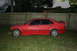 1996 BMW 3 Series - Side view of a red 1996 BMW 3 Series sedan parked on grass.