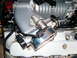 2004 Ford Crown Victoria - Close-up view of engine components, including an intake manifold and supercharger.