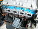 2004 Ford Crown Victoria - Detail of a 2004 Ford engine component, showing blue painted sections and stamped identification numbers.