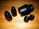 2004 Ford Crown Victoria - A collection of black anodized AN fittings and a large adapter are displayed on a wooden table.