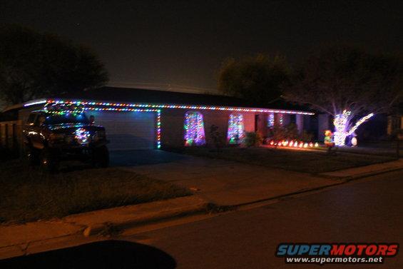 Dark 1990 Ford Bronco parked in driveway, decorated with Christmas lights
