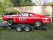 1968 Ford Torino - A red 1968 Ford Torino race car, identified by its body style and Ford badging, is seen on a trailer.