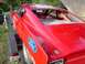 1968 Ford Torino - Red 1968 Ford Torino race car with roll cage, seen from the rear on a trailer.