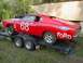 1968 Ford Torino - This red 1968 Ford Torino race car is loaded onto a trailer, ready for transport.