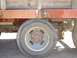 1978 Ford F-350 - This image shows the rear wheel and suspension of a truck, with a wooden bed above.