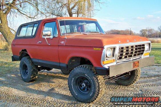 Red 1978 Ford Bronco 3/4 front view with aftermarket bumper and lifted suspension