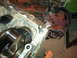 1990 Ford Bronco - A close-up view of an engine's internal components, including the crankshaft, in a workshop setting.