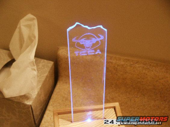 acrylic trophy with bull logo and 'TECA' text, lit from below