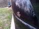 2007 Dodge Durango - A close-up of a dark-colored car door shows a significant rust patch.