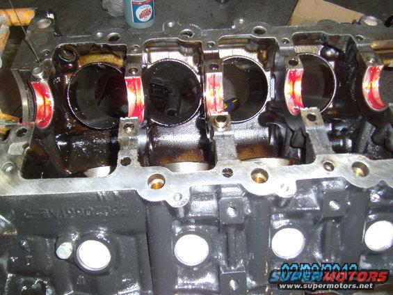 Engine block with crankshaft bearings visible, part of an engine overhaul