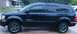 2007 Dodge Durango - Side profile of a black 2007 Dodge Durango, showing its body style and wheels.