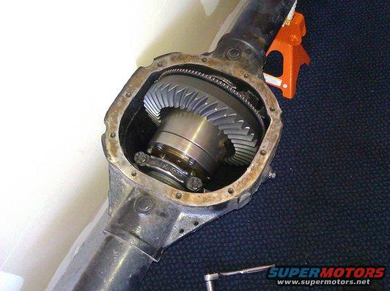 Differential housing with gears exposed. Orange jack stand in background