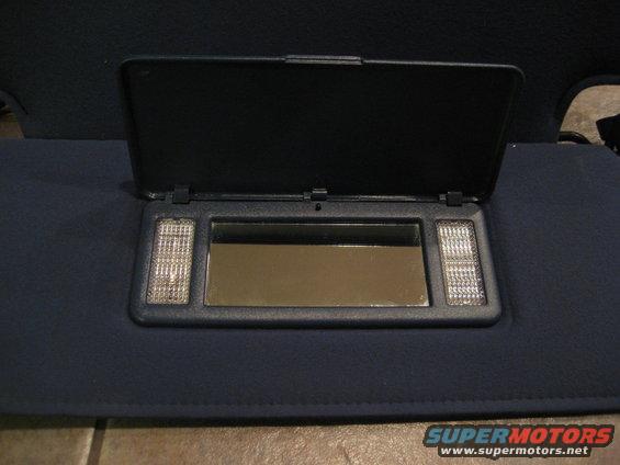 Dark blue sun visor with open lid revealing a mirror and two lights