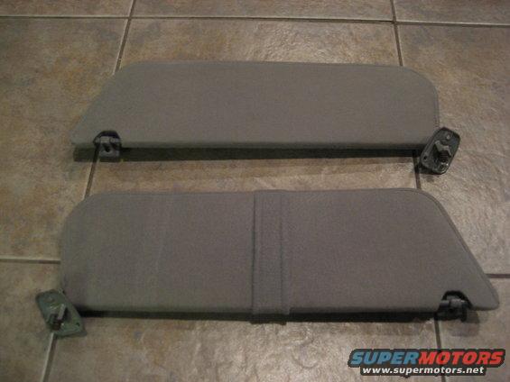 Two gray fabric sun visors with attached mounting hardware