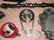 1971 Ford Ranchero - Engine timing components including a camshaft, timing chain, sprockets, and lifters are arranged on a surface.