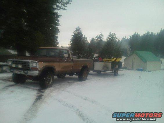 1979 Ford F-150 in snow towing trailer with ATV