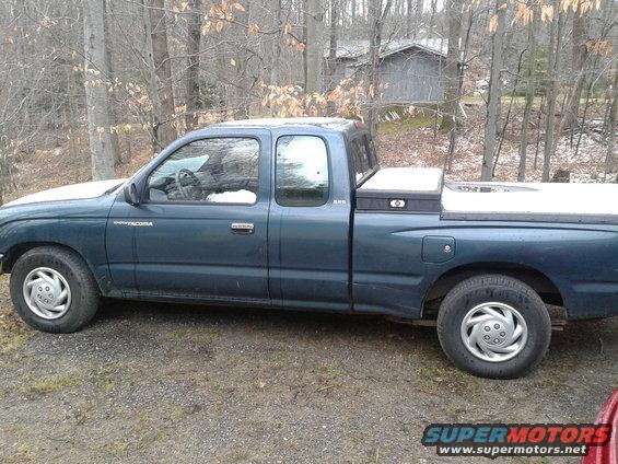 Blue Toyota Tacoma pickup truck parked outdoors with a toolbox in the bed