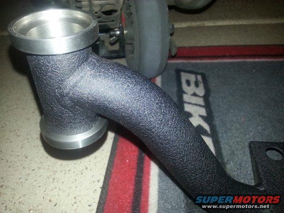 Black textured metal automotive intake pipe with silver fittings. Supermotors.net logo visible