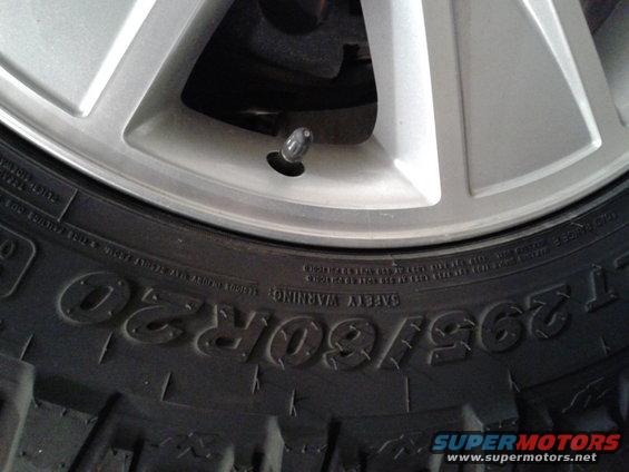 Close-up of a tire with size 295/60R20 and a silver alloy wheel