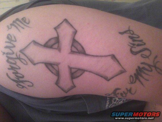 Tattoo of a cross with text 'Forgive me for all my sins' on skin