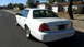 2001 Ford Crown Victoria - Rear 3/4 view of a white 2001 Ford Crown Victoria parked on a residential street.