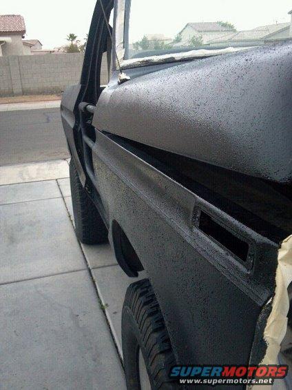 1978 Ford Bronco fender and door, painted black with textured finish. Door is open