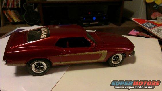 red model car with gold stripe and 'TEXAS' on rear window