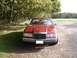 1992 Lincoln Mark VII - Front view of a red 1992 Lincoln Mark VII parked on a gravel surface.