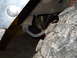 1992 Ford Bronco - A close-up view of a vehicle's suspension system and a large off-road tire, with a watermark from SuperMotors.net visible.