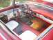 1956 Ford Thunderbird - Interior view of a 1956 Ford Thunderbird, red upholstery and a floor-mounted shifter.