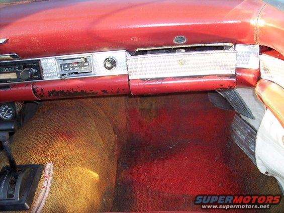 Dashboard of a 1956 Ford Thunderbird with radio and glove box