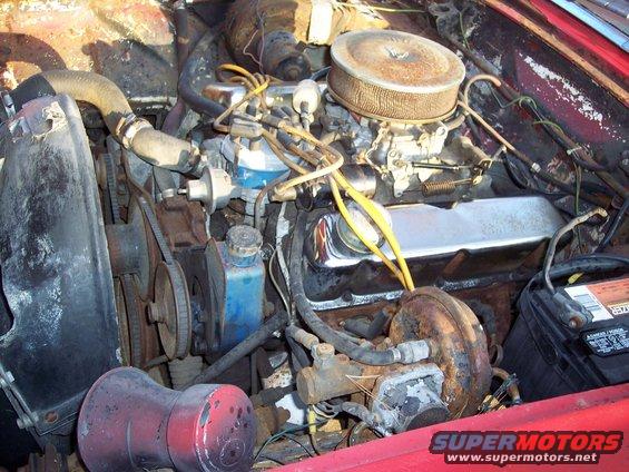 Engine bay with carburetor and air cleaner