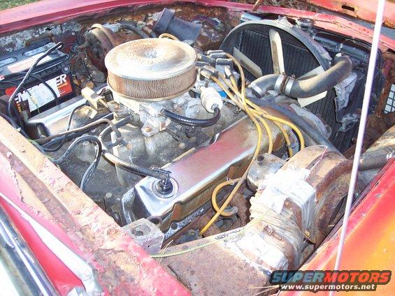 Engine bay with V8 engine, air cleaner, battery, and radiator
