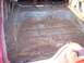 1956 Ford Thunderbird - Interior floor pan of a vehicle showing significant rust damage and exposed wiring.