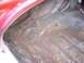 1956 Ford Thunderbird - The interior of a car trunk shows significant rust damage and visible wiring, with no clear year identification.