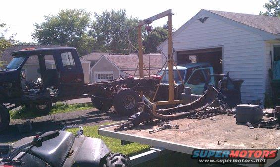 Truck chassis with engine hoist and parts on trailer